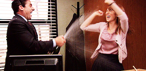 Michael from "The Office" spraying Erin with champagne